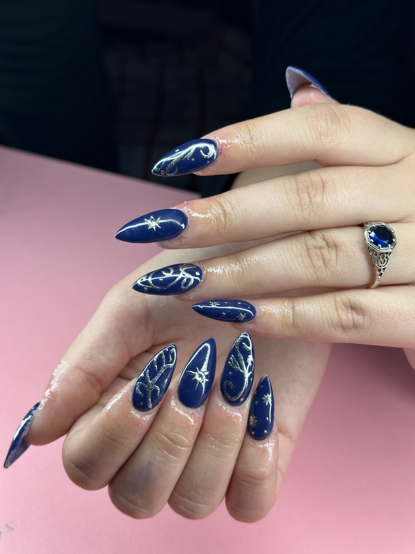 Deep blue celestial nails with silver scrollwork and stars by Serin